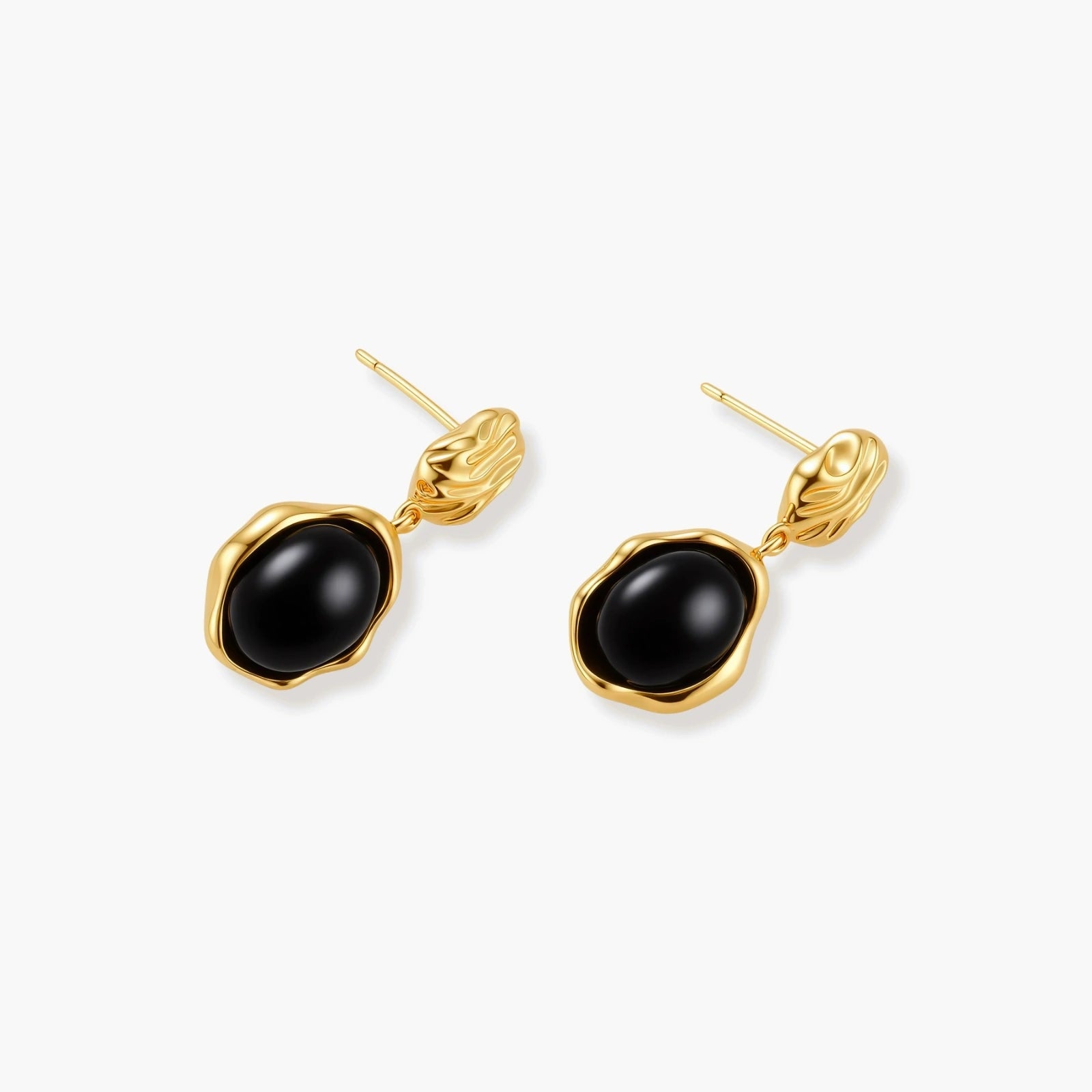Gold-plated rippled stud earrings with black agate stone drops on white background