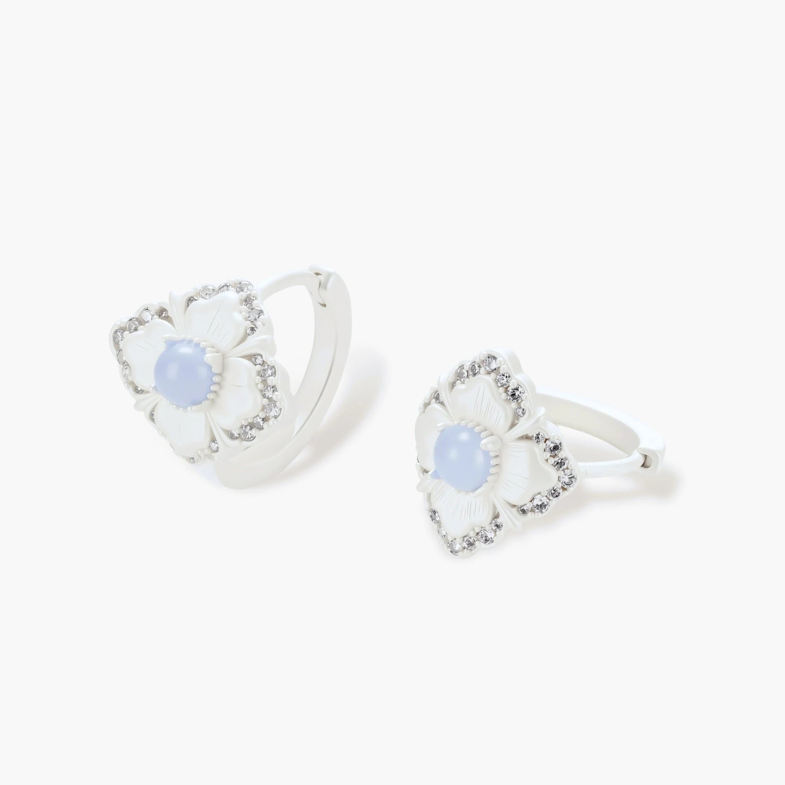 Silver-plated flower earrings with blue zirconia centers, featuring one stud and one huggie hoop in mismatched pair style.