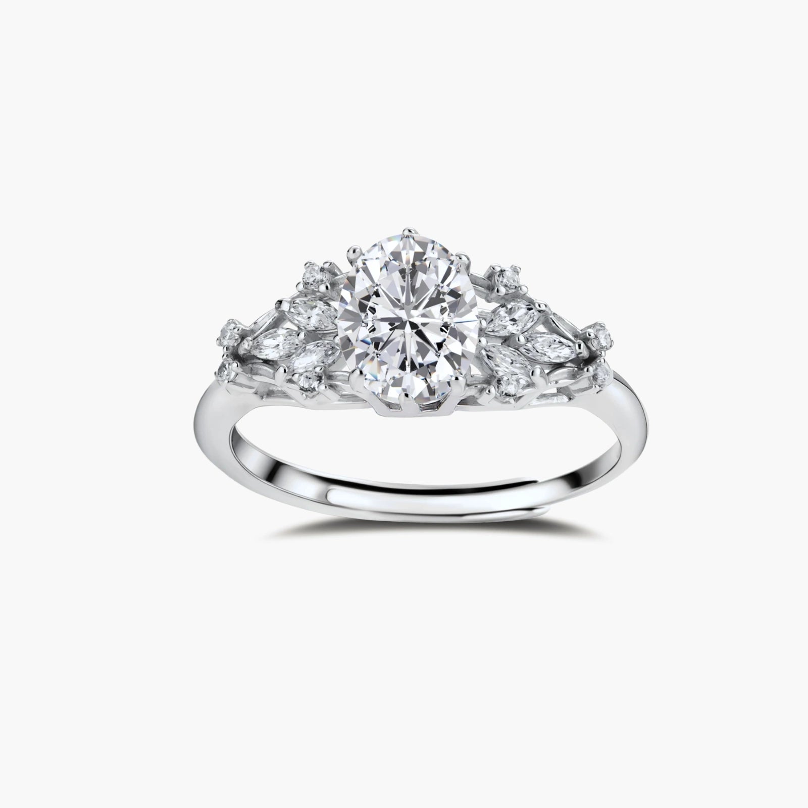 Sterling silver ring with oval moissanite center stone surrounded by smaller accent stones in ornate setting