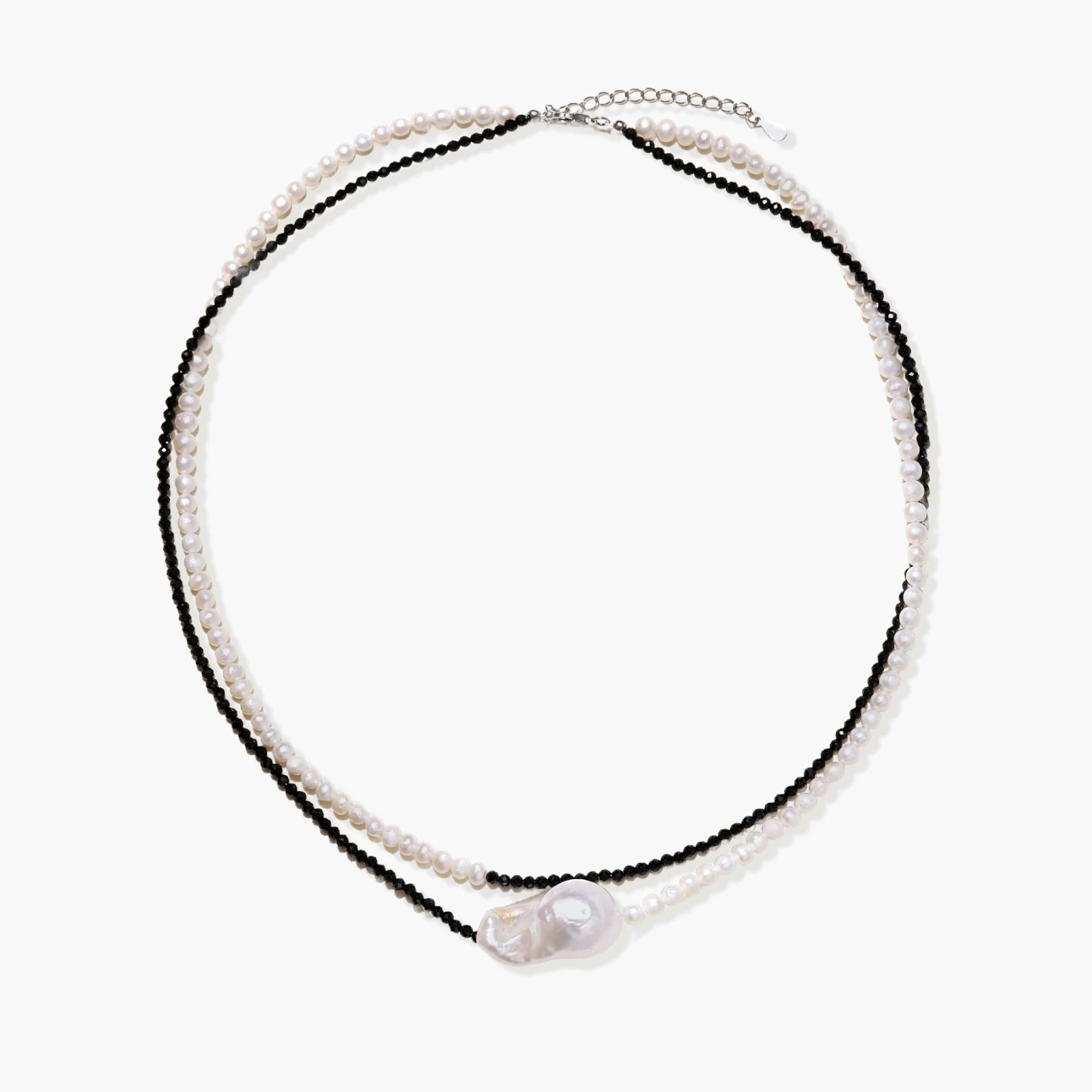 Double-strand necklace with black faceted quartz and white pearls featuring an oversized baroque pearl centerpiece