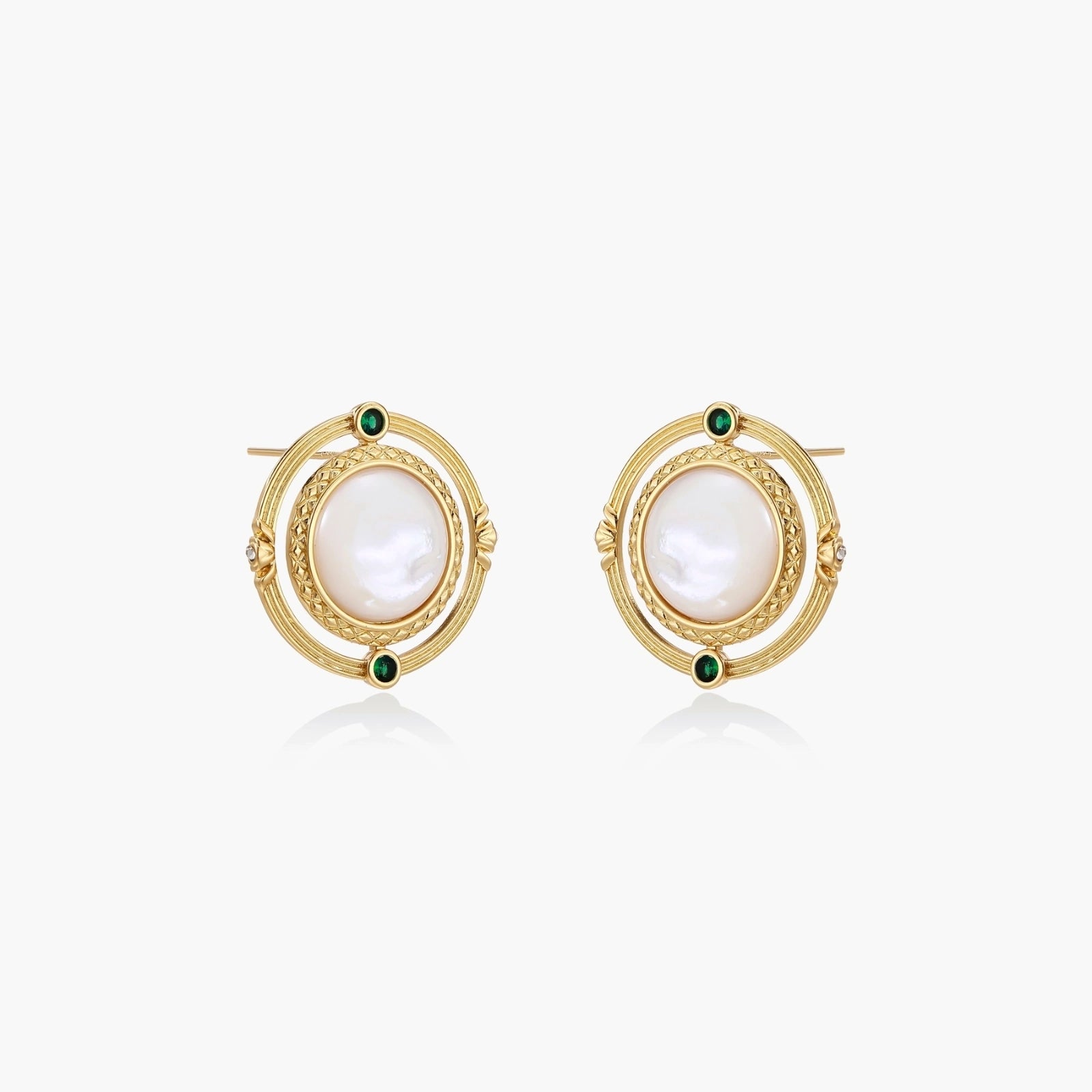 Circular gold stud earrings with iridescent mother-of-pearl center and green zirconia accents on cream background.