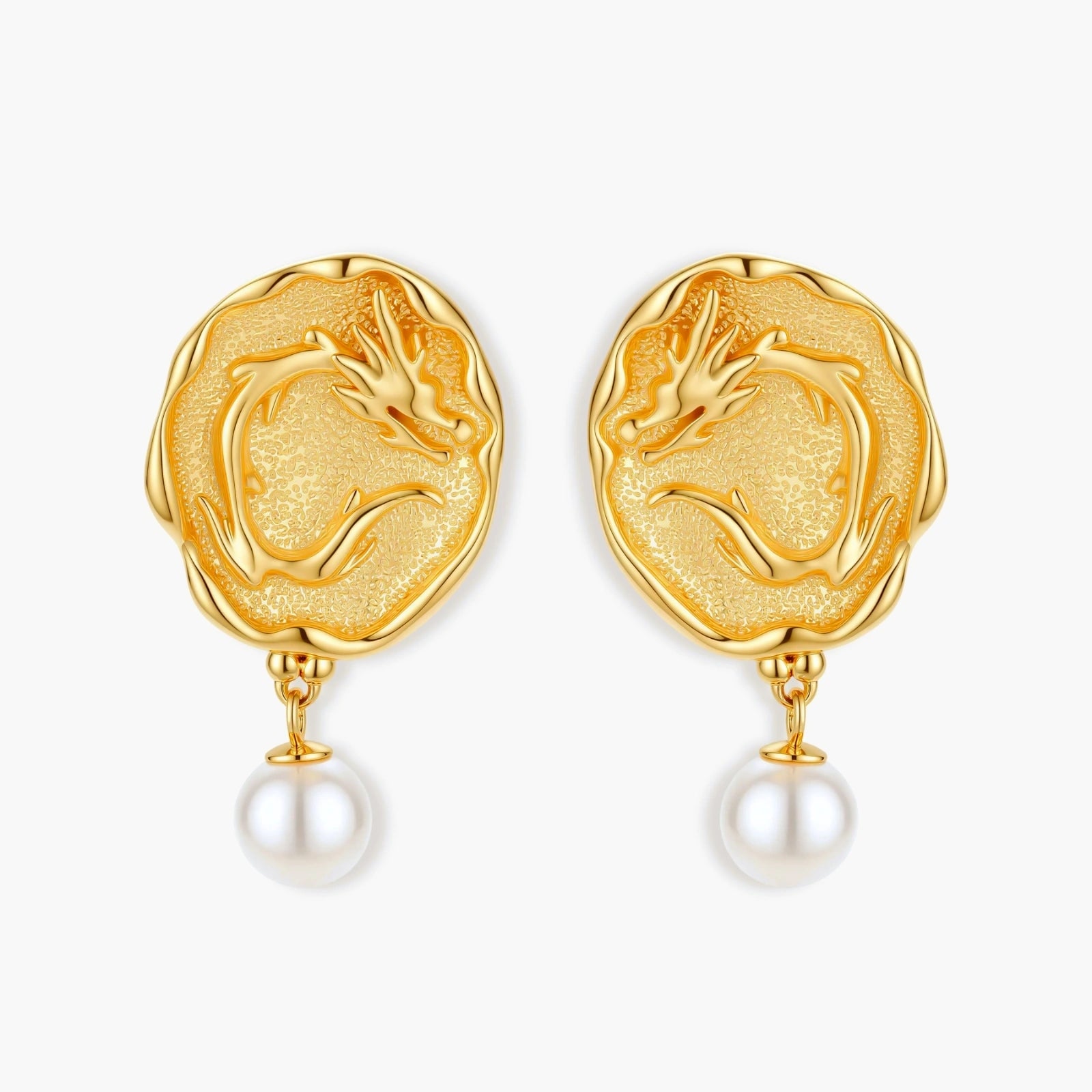 Ornate gold-plated dragon medallion earrings with white shell pearl drops on beige background, featuring detailed Chinese motifs.