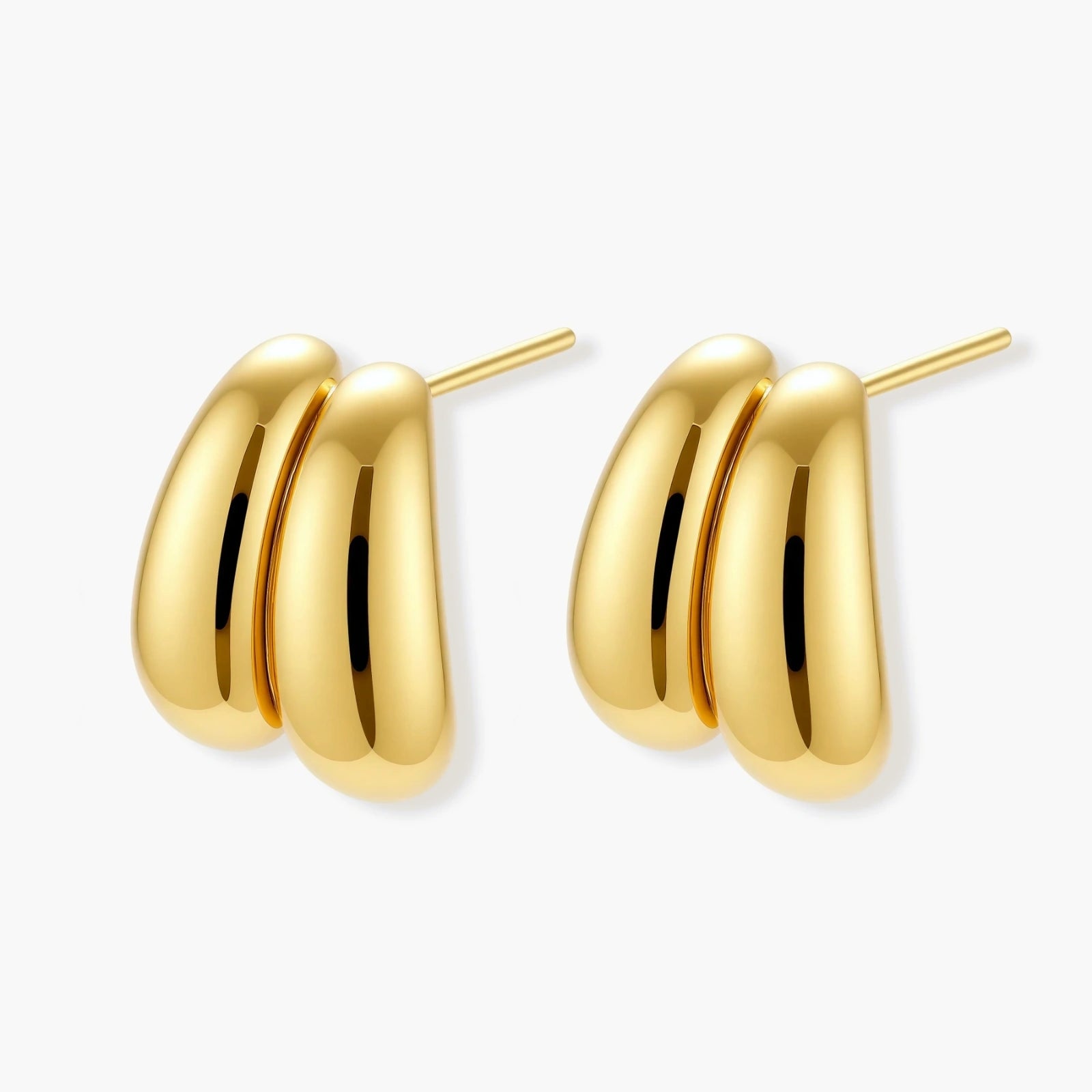 Chunky 18K gold-plated sterling silver hoop earrings with flowing sculptural curves on white background.
