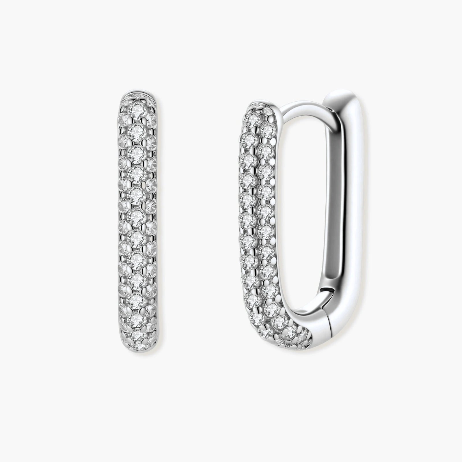 Close-up of platinum-plated sterling silver huggie hoops with pavé crystal setting on white background.