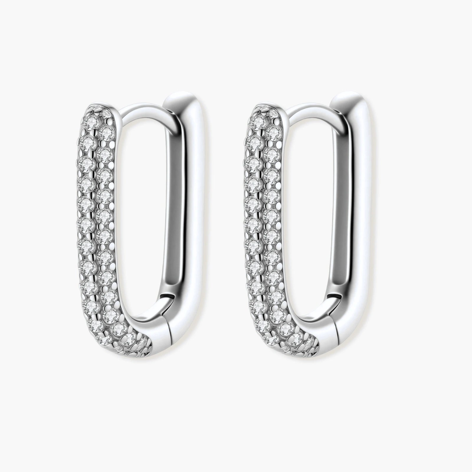Close-up of platinum-plated sterling silver huggie hoops with pavé crystal setting on white background.