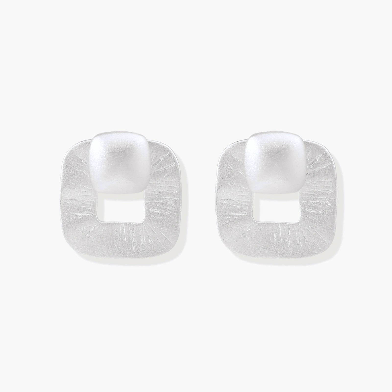 Pair of geometric sterling silver earrings with frosted square frames and glossy rounded studs on white background