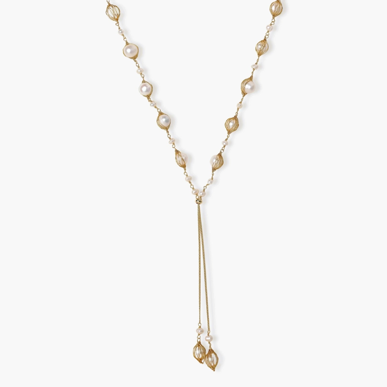 Adjustable gold lariat necklace with freshwater pearls nested in delicate cage settings and Y-shaped tassel drop