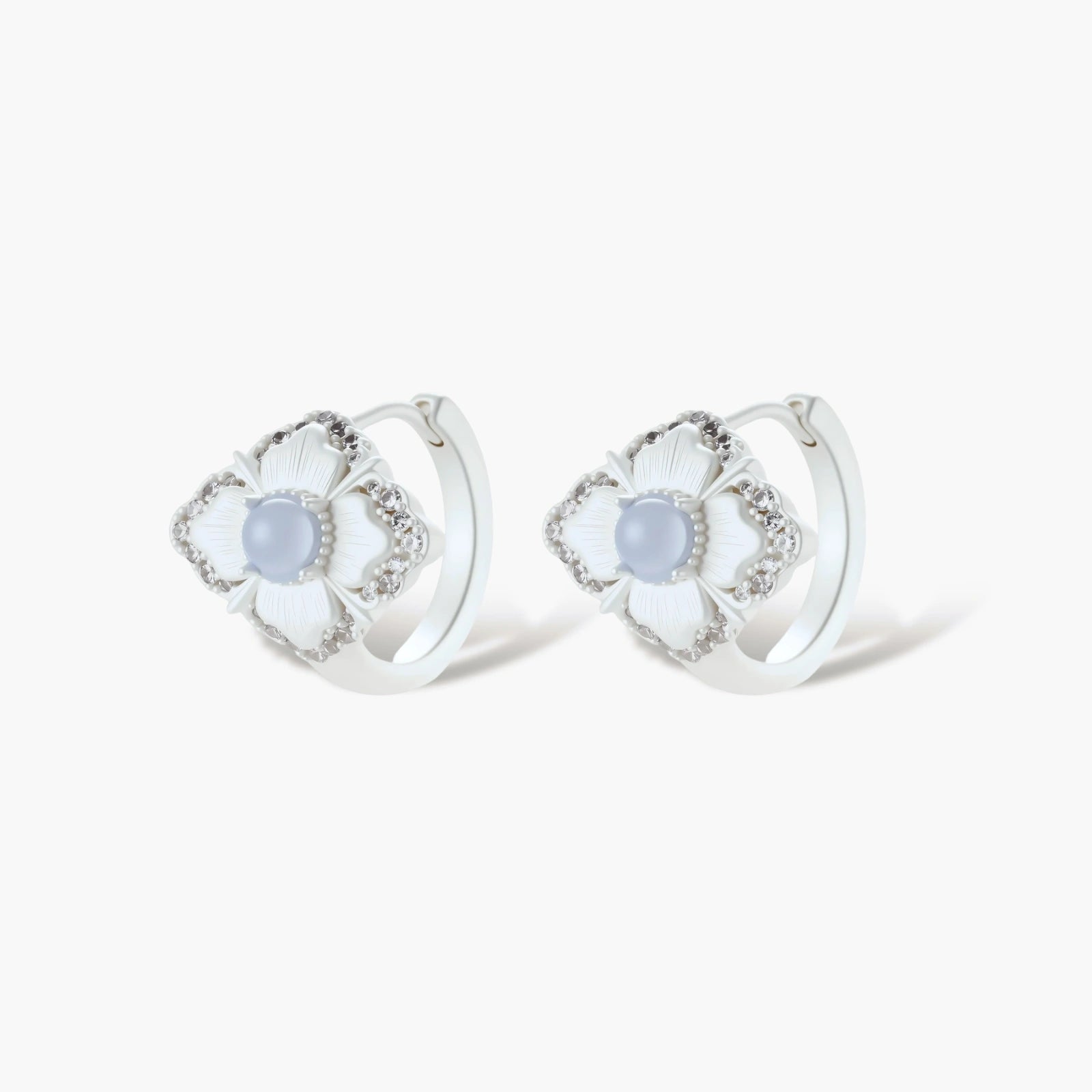 Silver-plated flower earrings with blue zirconia centers, featuring one stud and one huggie hoop in mismatched pair style.
